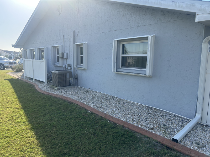 Clear polycarbonate hurricane panels allowing light into a Florida home during a storm.